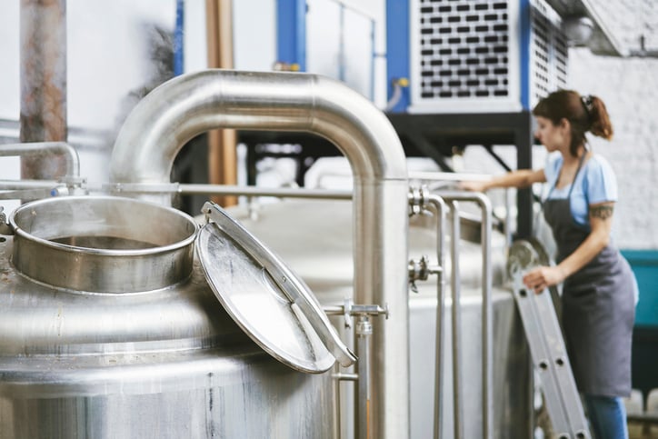 woman tending to food and beverage tank