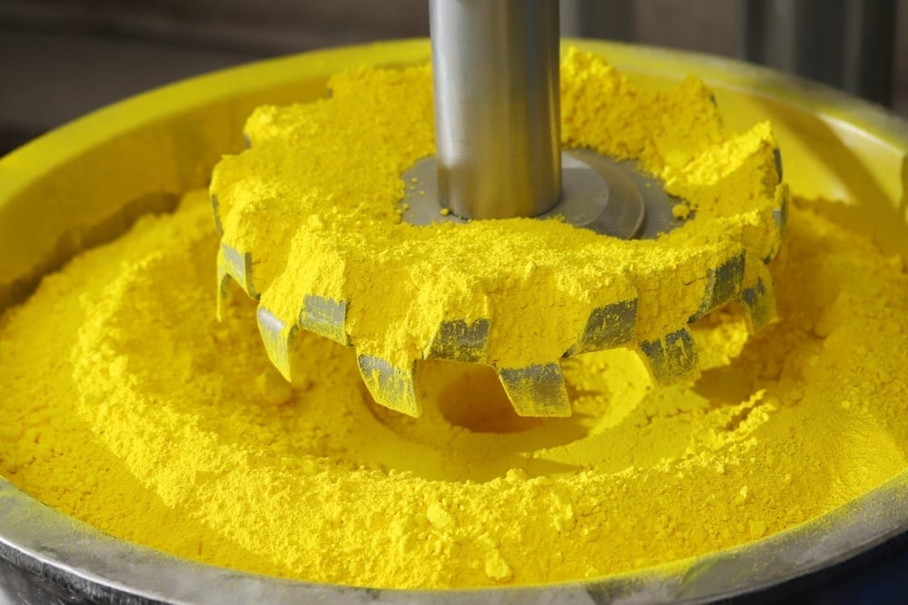 yellow pigment for paint dispersion sitting in tank with dispersion blade impeller